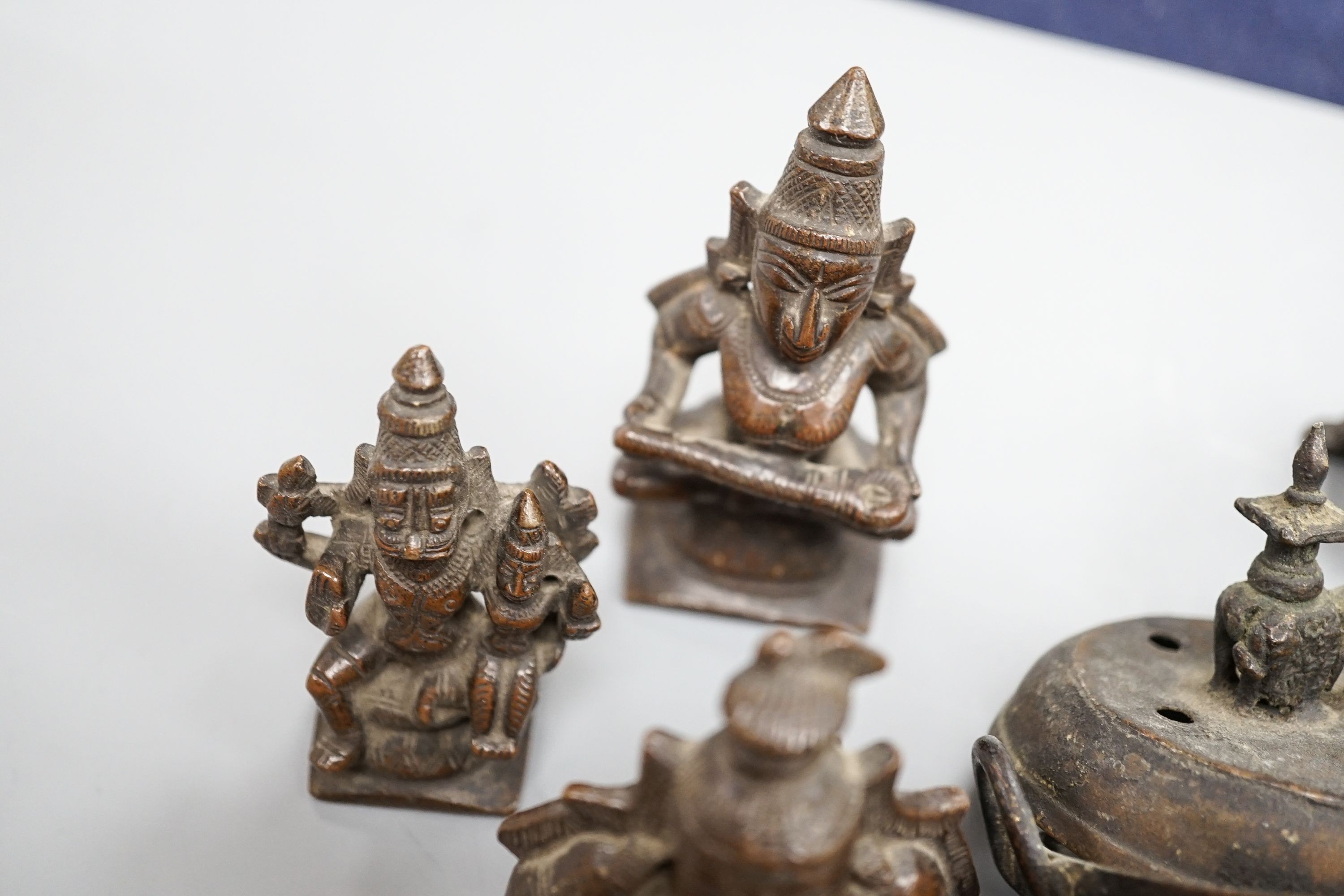 A Chinese gilt copper figure, a Chinese Dog of Fo, a bell, a censer, six Indian bronze figures and a scroll box